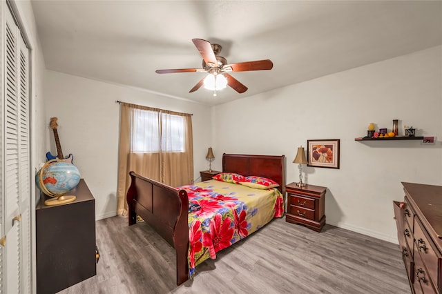 bedroom featuring wood-type flooring, a closet, and ceiling fan