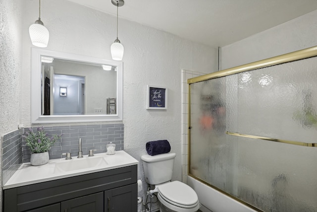 full bathroom featuring vanity, toilet, backsplash, and combined bath / shower with glass door