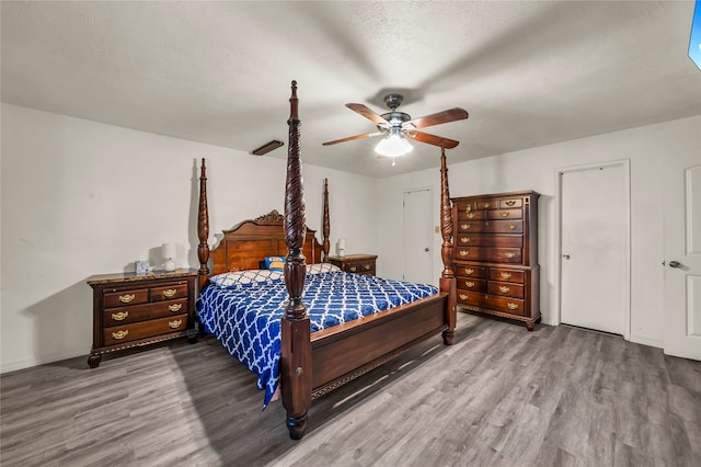 bedroom featuring ceiling fan, a textured ceiling, and hardwood / wood-style flooring