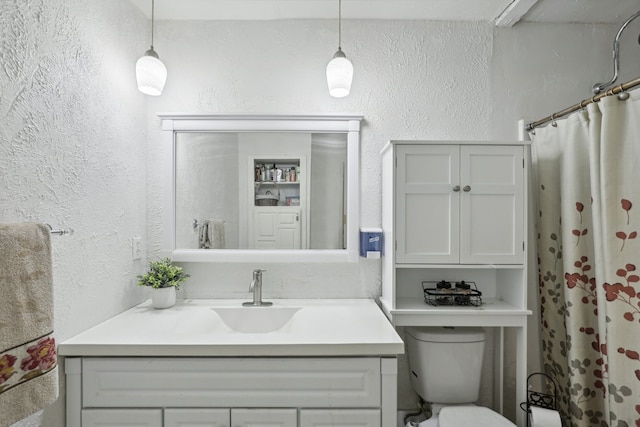 bathroom with vanity, toilet, and walk in shower