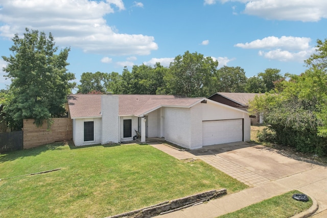 ranch-style house featuring a garage and a front lawn