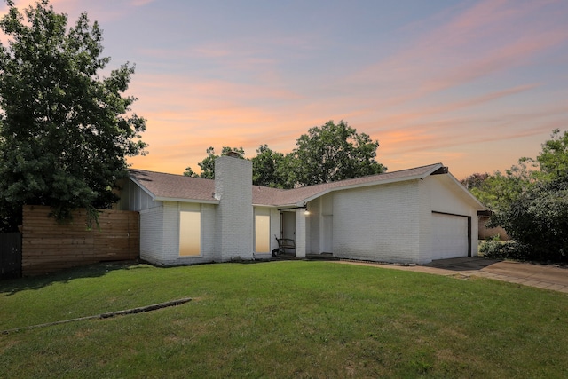 view of front facade featuring a yard and a garage