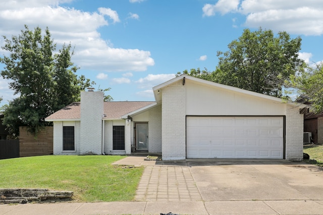 ranch-style home featuring a garage, a front lawn, and central air condition unit