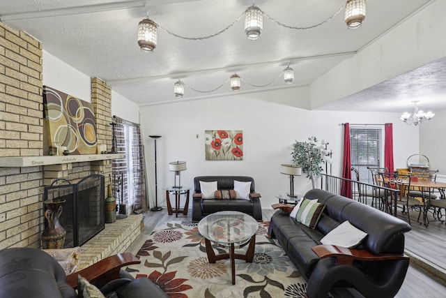 living room featuring light hardwood / wood-style flooring, an inviting chandelier, and a brick fireplace