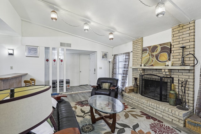 living room featuring a fireplace, hardwood / wood-style floors, and lofted ceiling