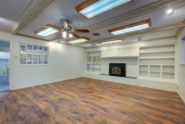 unfurnished living room featuring a fireplace, wood-type flooring, crown molding, and ceiling fan