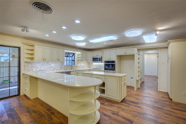 kitchen with a peninsula, visible vents, light countertops, appliances with stainless steel finishes, and open shelves