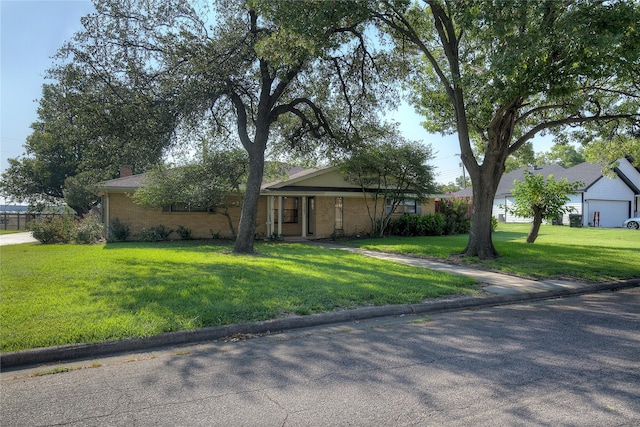 single story home featuring a garage and a front lawn