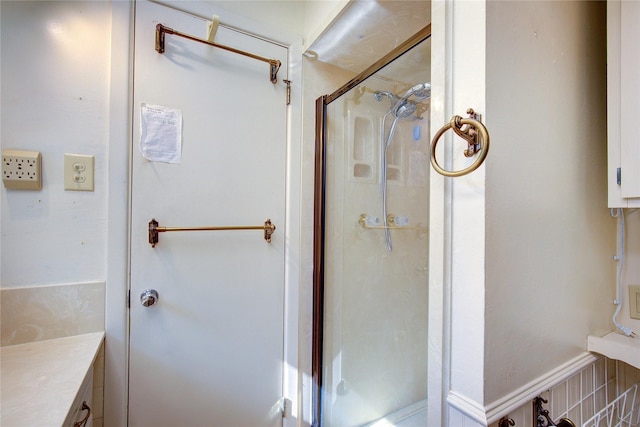 full bath featuring a stall shower and vanity