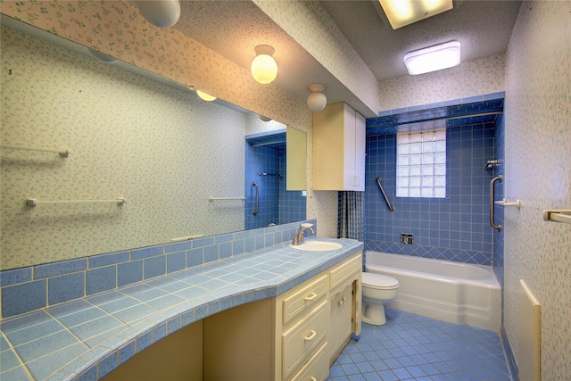 full bathroom featuring a textured ceiling, vanity, tile patterned flooring, and toilet