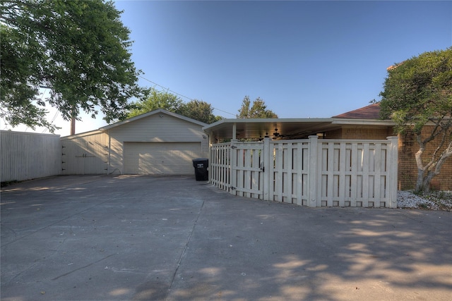 detached garage featuring fence