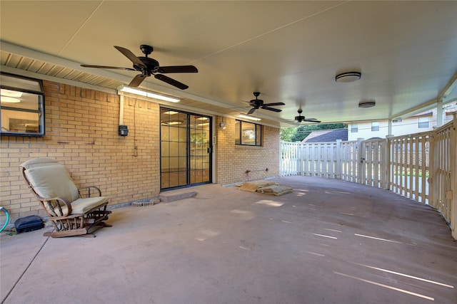 view of patio / terrace with fence and a ceiling fan