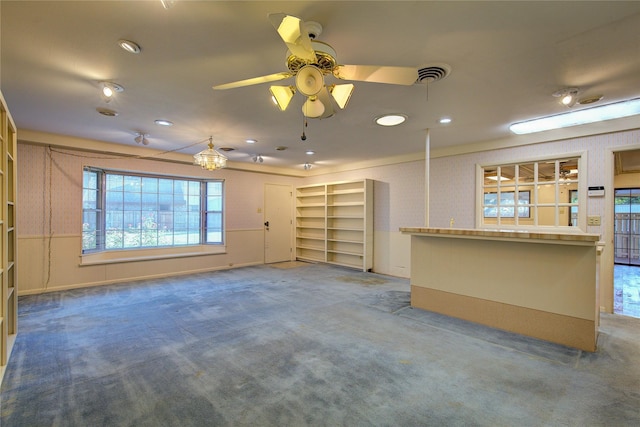 unfurnished living room featuring visible vents, ceiling fan, and carpet flooring