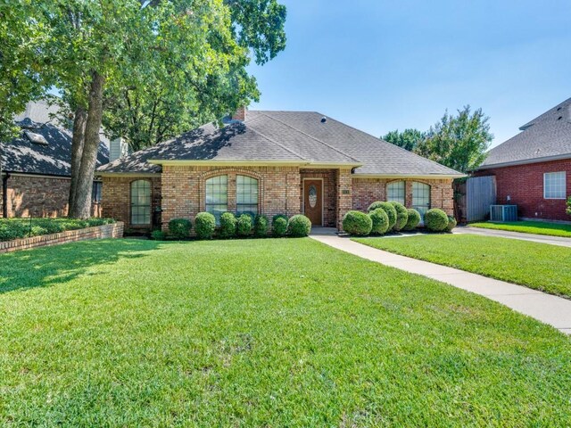 single story home featuring central AC and a front yard