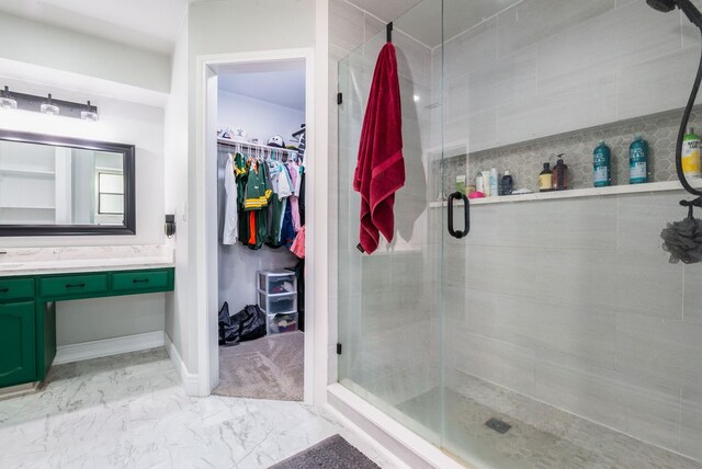 bathroom featuring an enclosed shower, vanity, and tile patterned flooring