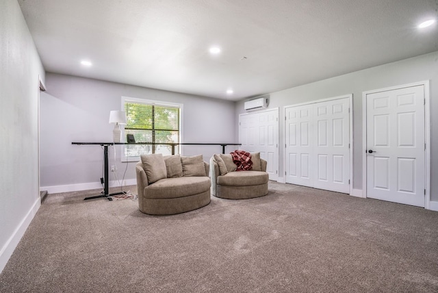 living room with an AC wall unit and carpet floors