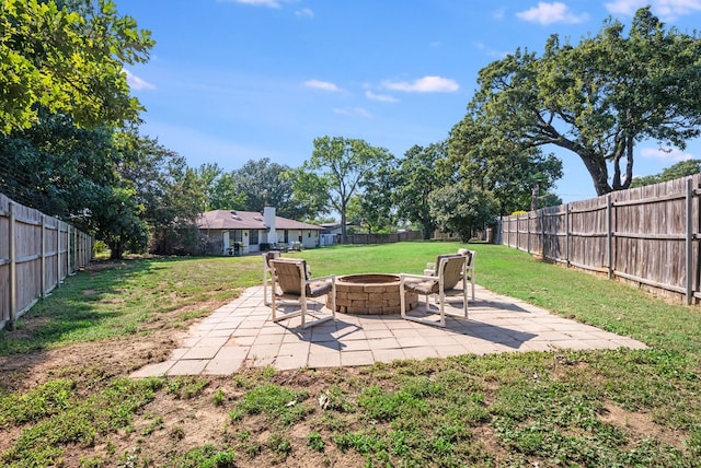 view of yard featuring a patio and an outdoor fire pit