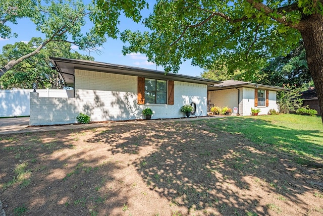 ranch-style home featuring a front yard