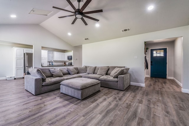 living room featuring high vaulted ceiling, hardwood / wood-style floors, and ceiling fan