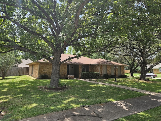 single story home featuring a front lawn