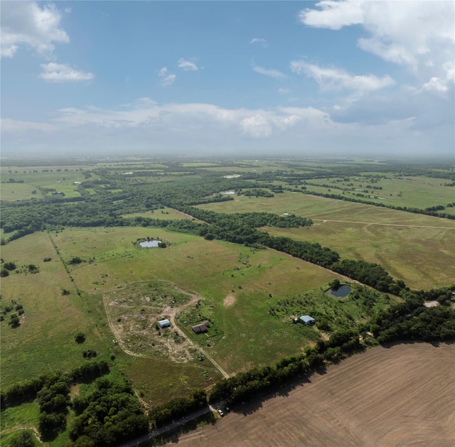 birds eye view of property with a rural view