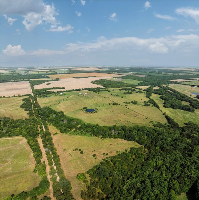 birds eye view of property with a rural view