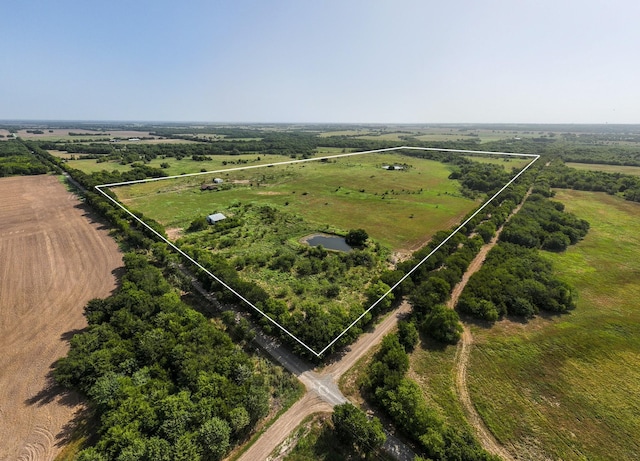 birds eye view of property with a rural view