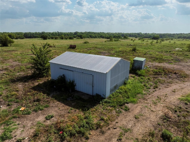 view of pole building with a rural view