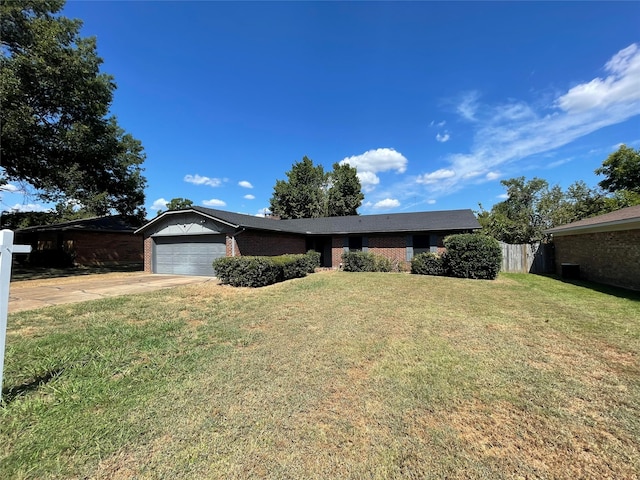 ranch-style house featuring a front lawn and a garage