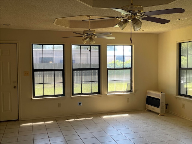 empty room featuring plenty of natural light, ceiling fan, and light tile patterned floors