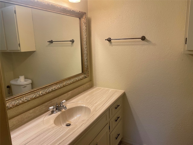 bathroom featuring toilet and vanity