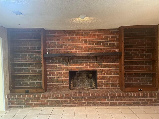 unfurnished living room with a textured ceiling, brick wall, and light tile patterned flooring