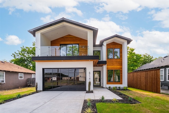 modern home with a front yard and a balcony