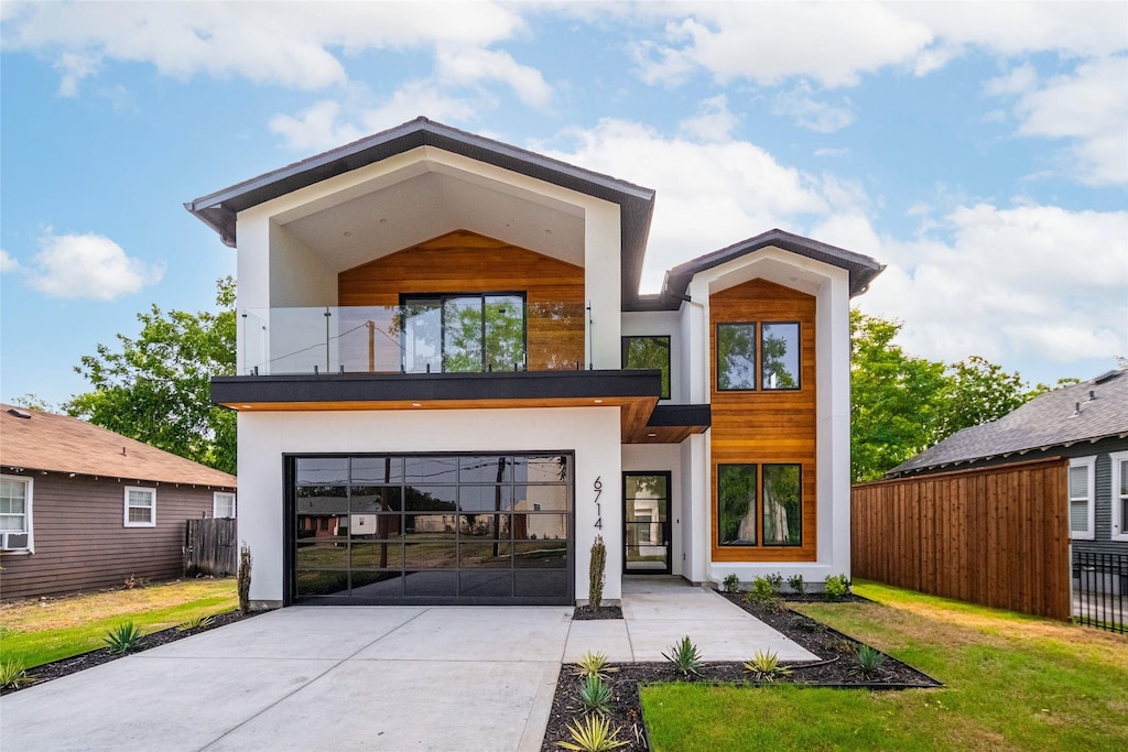 view of front of property featuring a balcony and a front lawn