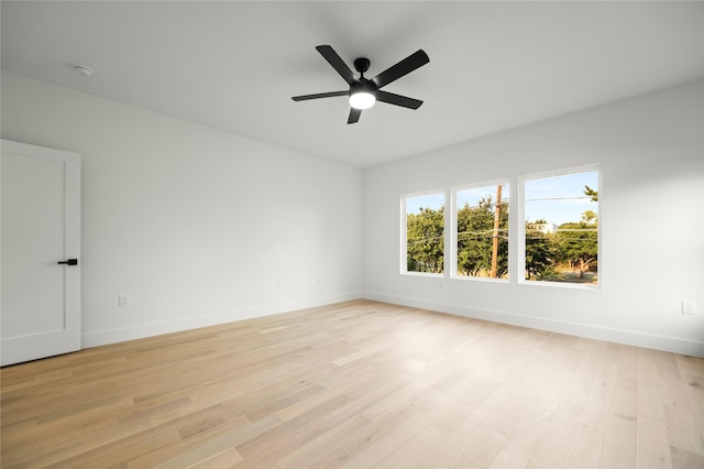 unfurnished room with ceiling fan and light wood-type flooring