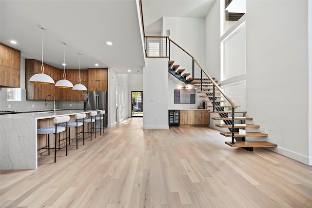 interior space with a high ceiling and light wood-type flooring