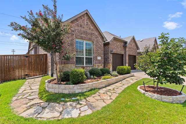 view of front of property with a garage and a front lawn