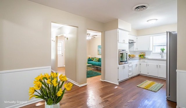 kitchen featuring white cabinetry, sink, stainless steel appliances, and dark hardwood / wood-style floors