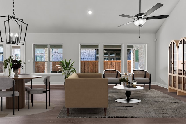 living room featuring a healthy amount of sunlight, dark hardwood / wood-style floors, and ceiling fan with notable chandelier