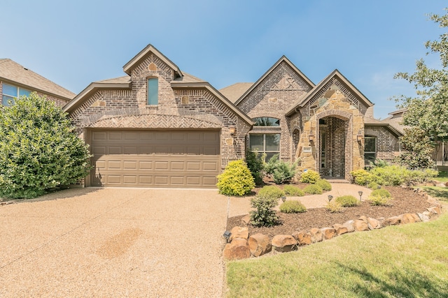 view of front of home with a garage and a front lawn