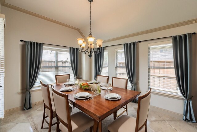 dining area featuring ornamental molding, a chandelier, plenty of natural light, and light tile patterned floors