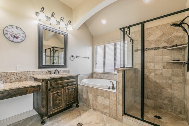 bathroom featuring vaulted ceiling, vanity, separate shower and tub, and tile patterned floors