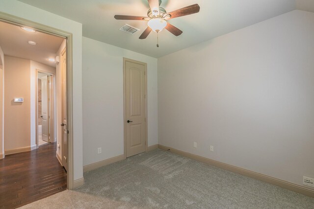 unfurnished bedroom with dark hardwood / wood-style flooring and ceiling fan