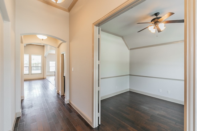 corridor with ornamental molding, vaulted ceiling, and dark wood-type flooring