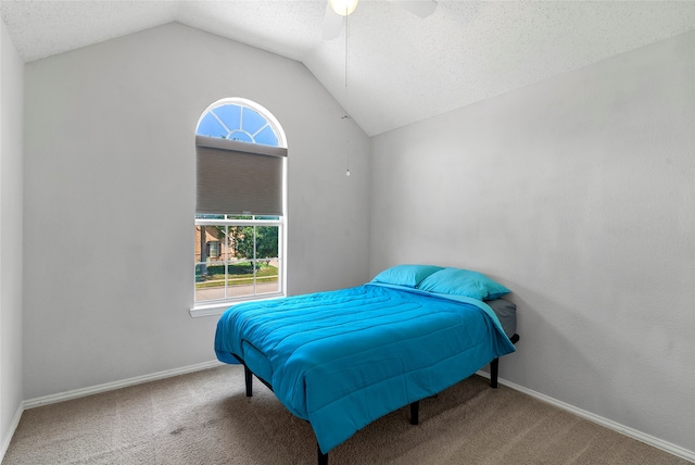 carpeted bedroom featuring ceiling fan, a textured ceiling, and lofted ceiling