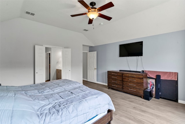 bedroom with lofted ceiling, connected bathroom, ceiling fan, and light hardwood / wood-style floors