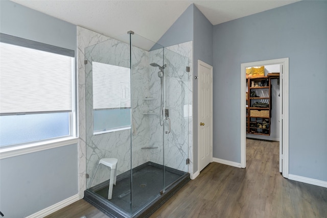 bathroom featuring an enclosed shower and hardwood / wood-style flooring