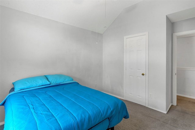 bedroom with vaulted ceiling and carpet floors