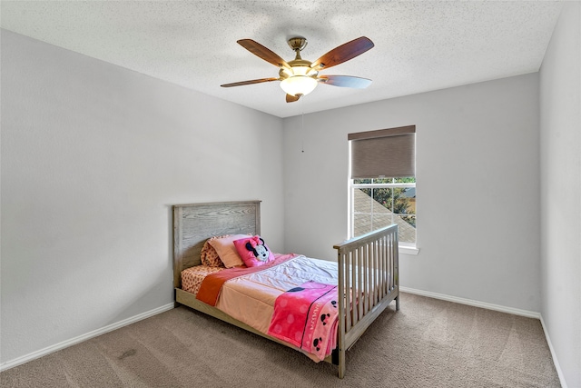 carpeted bedroom with ceiling fan and a textured ceiling