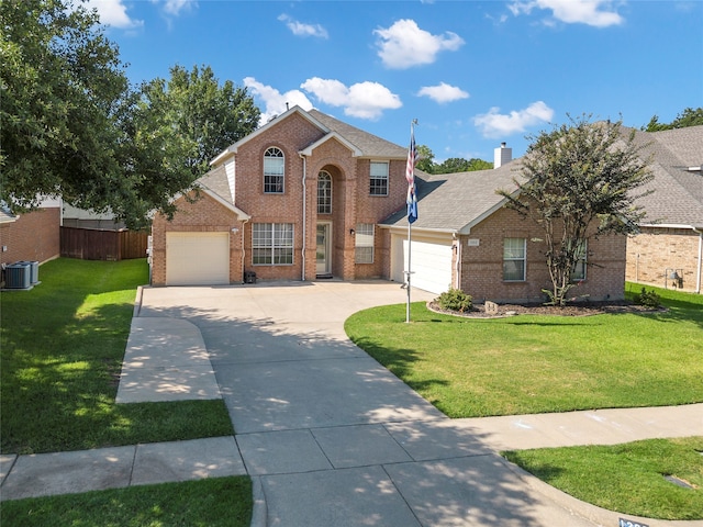 view of front property with a garage, central air condition unit, and a front lawn